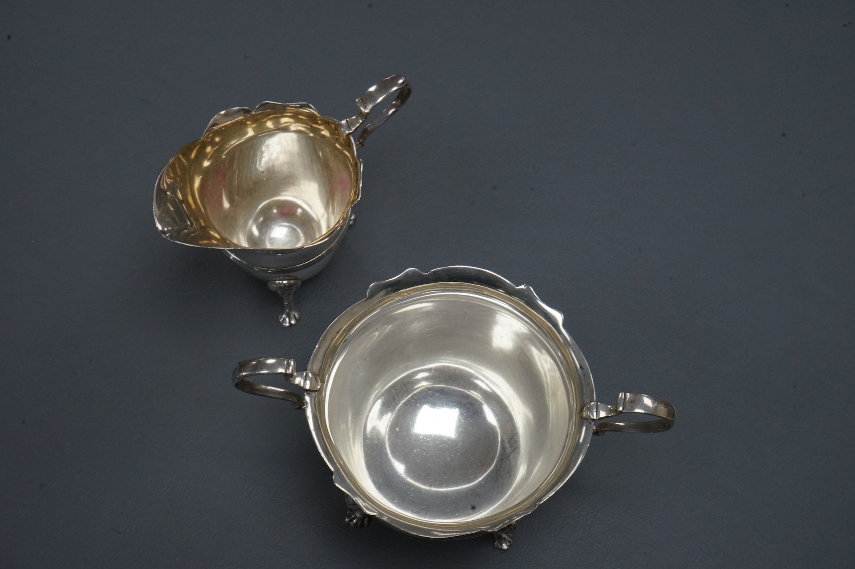An Edwardian silver two handled sugar bowl and matching cream jug, by John Milward Banks, Chester, 1908, 13.6oz.
